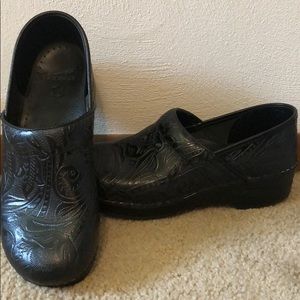 Black danskos with design.